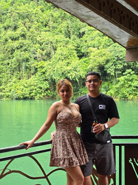 Rica Mae and Mark Lino standing together beside a green river