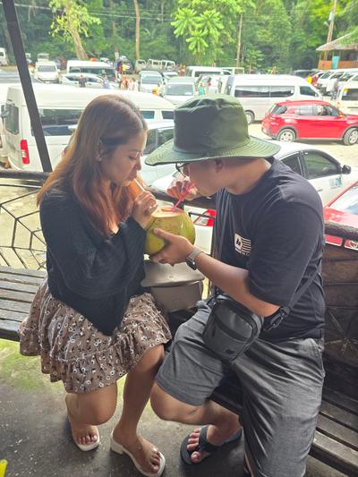 Rica Mae and Mark Lino sharing one fresh coconut, each with a straw